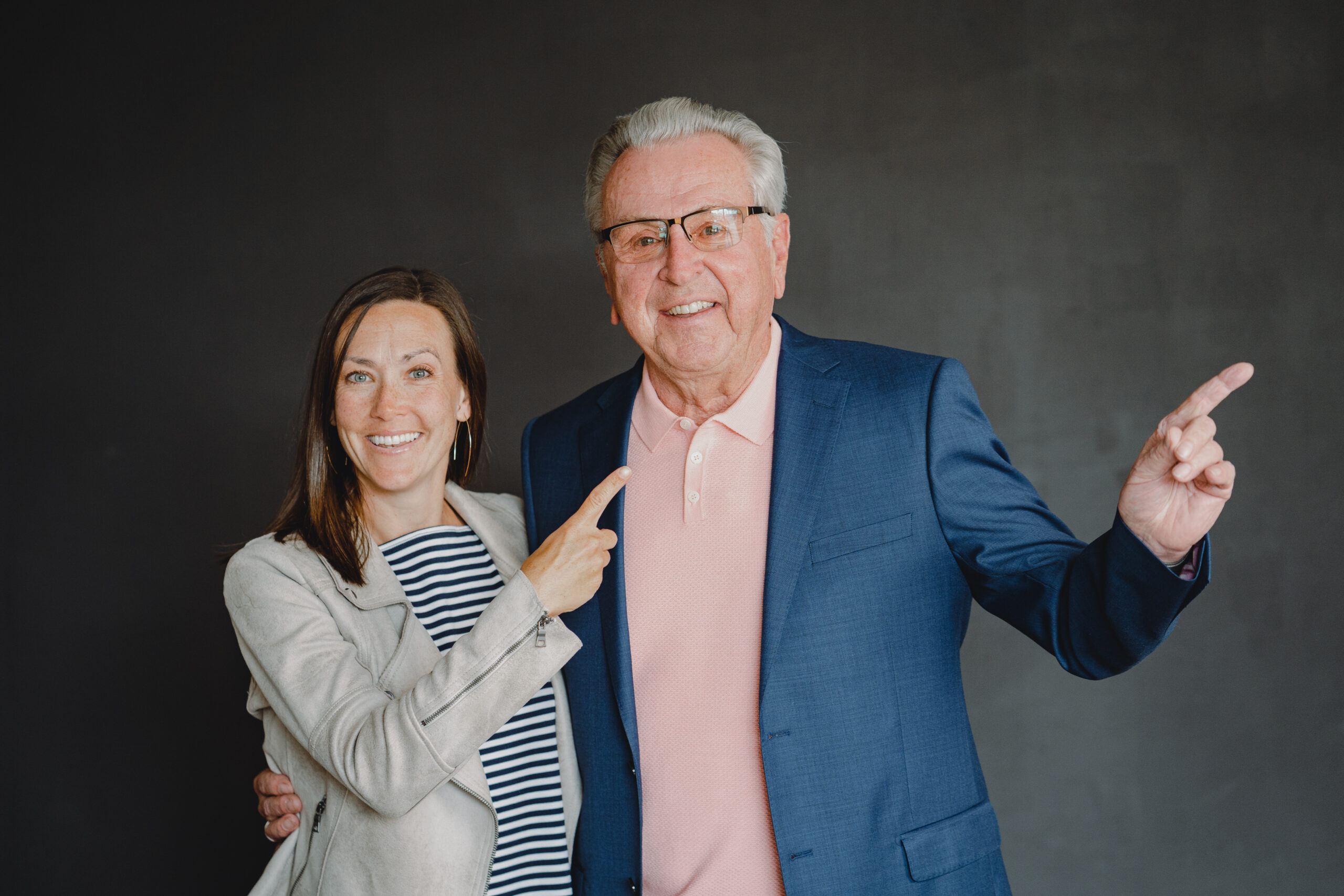Co-founders Sara Frasca and Michael Smith pointing up and to the right to show the trajectory of how strategic planning for business can work.